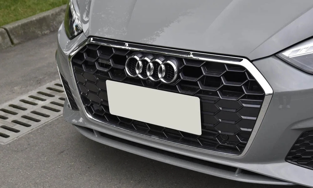 Фото Audi A5 (2024) — решётка радиатора. Фирменный рисунок облицовки — визитная карточка марки. За решёткой у многих комплектаций стоит радар адаптивного круиз-контроля Audi A5 (2024) — решётка радиатора