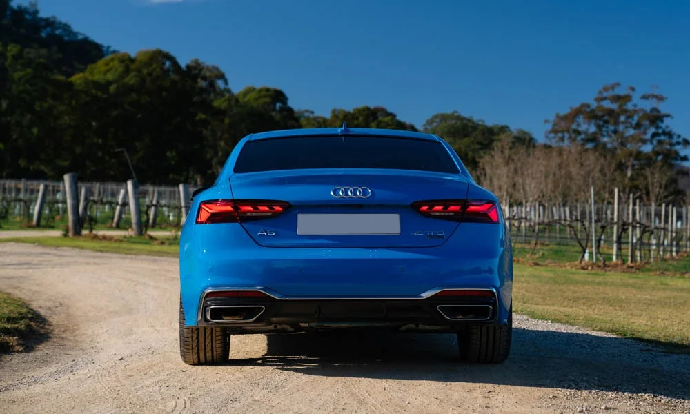 Фото Audi A5 — вид сзади, фото 14. Синий кузов сзади — фонари и бампер определяют ночной образ модели. Насадки выхлопа или их имитация внизу бампера различают версии Audi A5 — вид сзади, фото 14