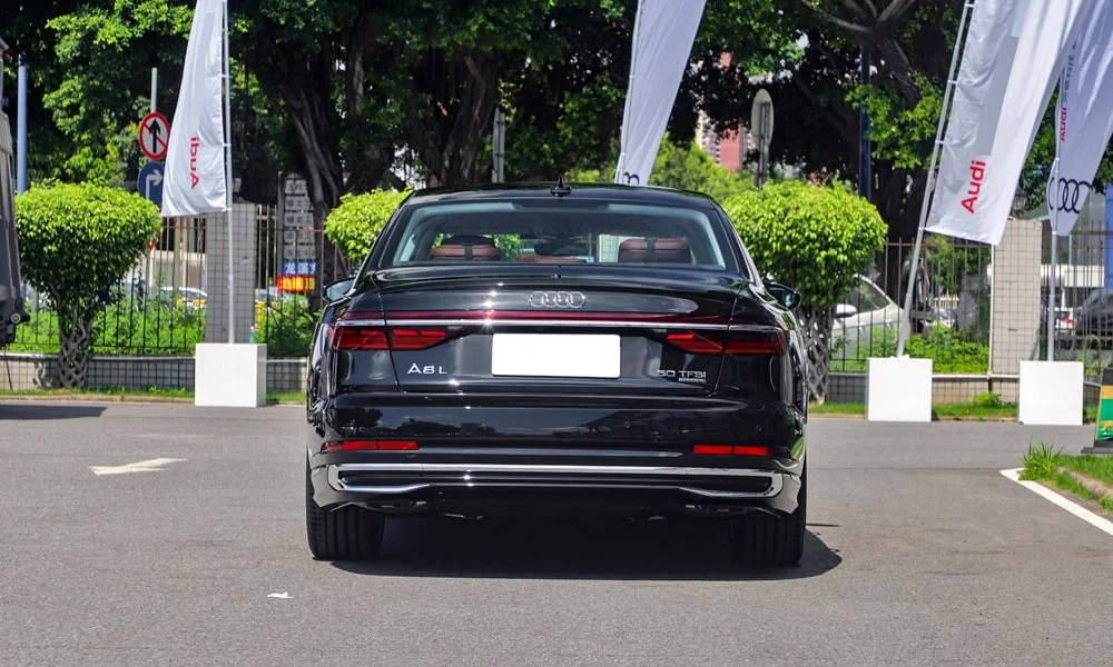 Фото Audi A8 L (2024) — вид сзади, фото 5. Корма в чёрном цвете: графика фонарей и пластика пятой двери. Насадки выхлопа или их имитация внизу бампера различают версии Audi A8 L (2024) — вид сзади, фото 5