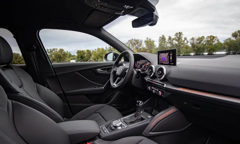 Фото Audi Q2 — интерьер, фото 2. Общий план салона: посадка, материалы и организация пространства в тёмной гамме. Светлая гамма зрительно расширяет салон, тёмная — практичнее в уходе Audi Q2 — интерьер, фото 2