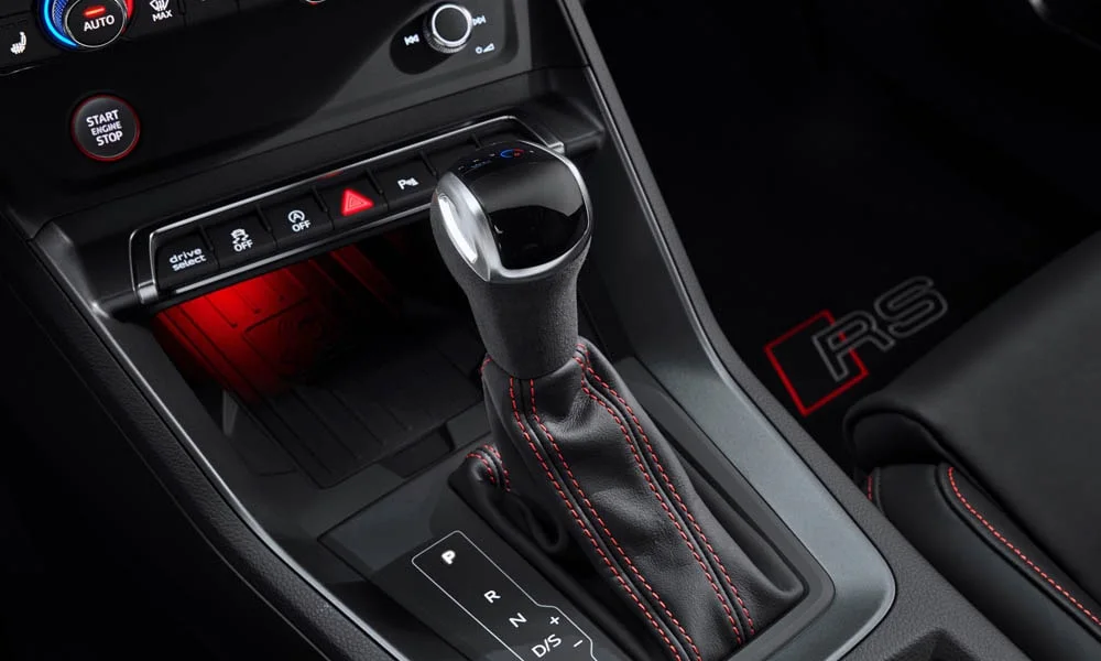 Фото Audi RS Q3 (2024) — селектор коробки передач. Селектор трансмиссии на центральной консоли. Режимы движения и электронный ручник собраны рядом с селектором Audi RS Q3 (2024) — селектор коробки передач