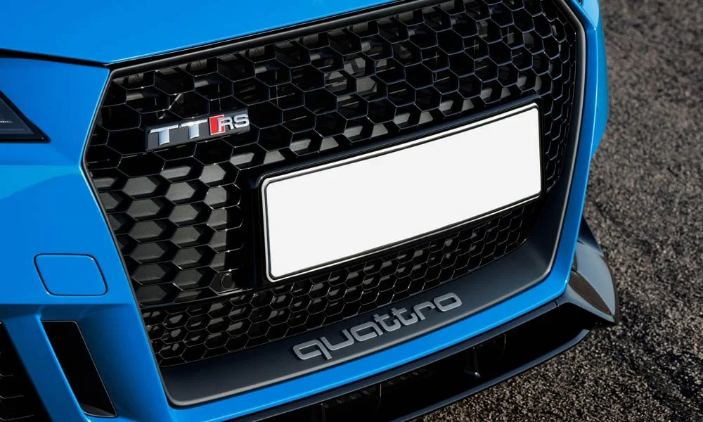 Фото Audi TT RS — решётка радиатора. Фирменный рисунок облицовки — визитная карточка марки. За решёткой у многих комплектаций стоит радар адаптивного круиз-контроля Audi TT RS — решётка радиатора