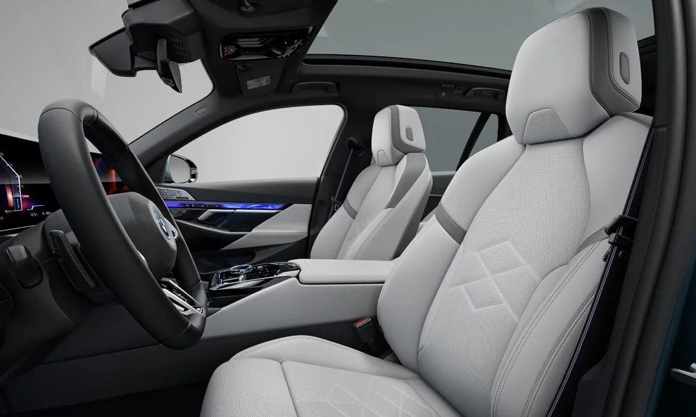 Фото BMW i5 Touring — передние сиденья. Передние кресла в перфорированной коже. Регулировки с памятью возвращают кресло под водителя одним нажатием — у версий с электроприводом BMW i5 Touring — передние сиденья