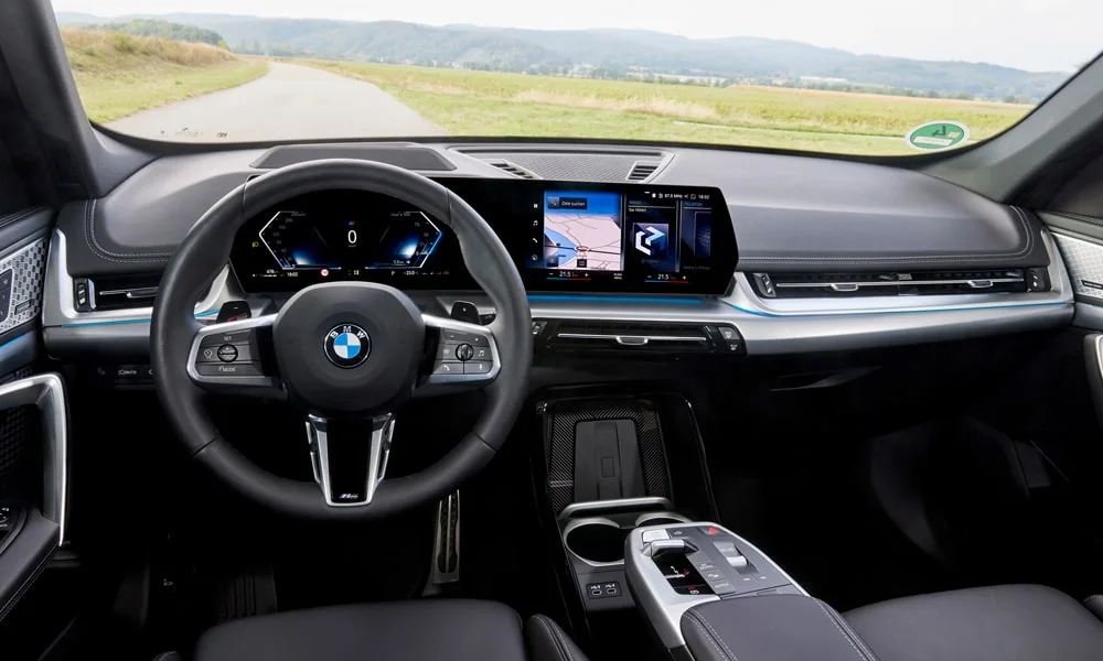 Фото BMW X1 (2024) — интерьер, фото 4. Общий план салона: архитектура панели, консоль и кресла. Уровень отделки читается по стыкам панелей и мягким поверхностям в зонах касания BMW X1 (2024) — интерьер, фото 4