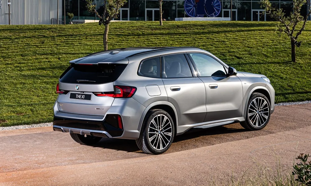 Фото BMW X1 (2024) — вид сзади, фото 4. Корма в серебристом цвете: графика фонарей и пластика пятой двери. Насадки выхлопа или их имитация внизу бампера различают версии BMW X1 (2024) — вид сзади, фото 4
