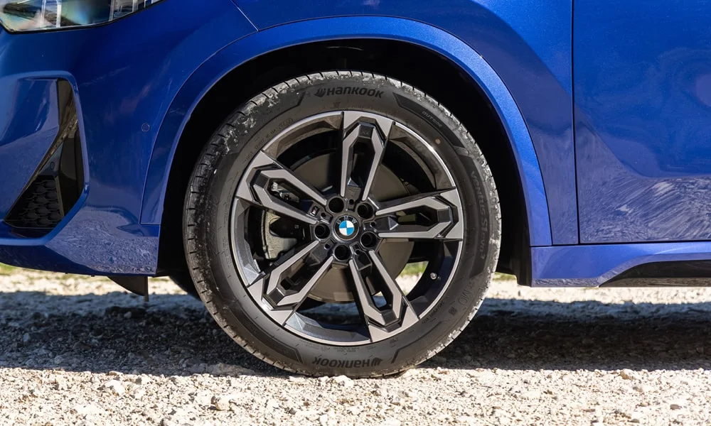 Фото BMW X1 (2024) — колесо и диск. Дизайн спиц и профиль резины крупным планом. При подборе зимнего комплекта сохраняйте наружный диаметр колеса BMW X1 (2024) — колесо и диск