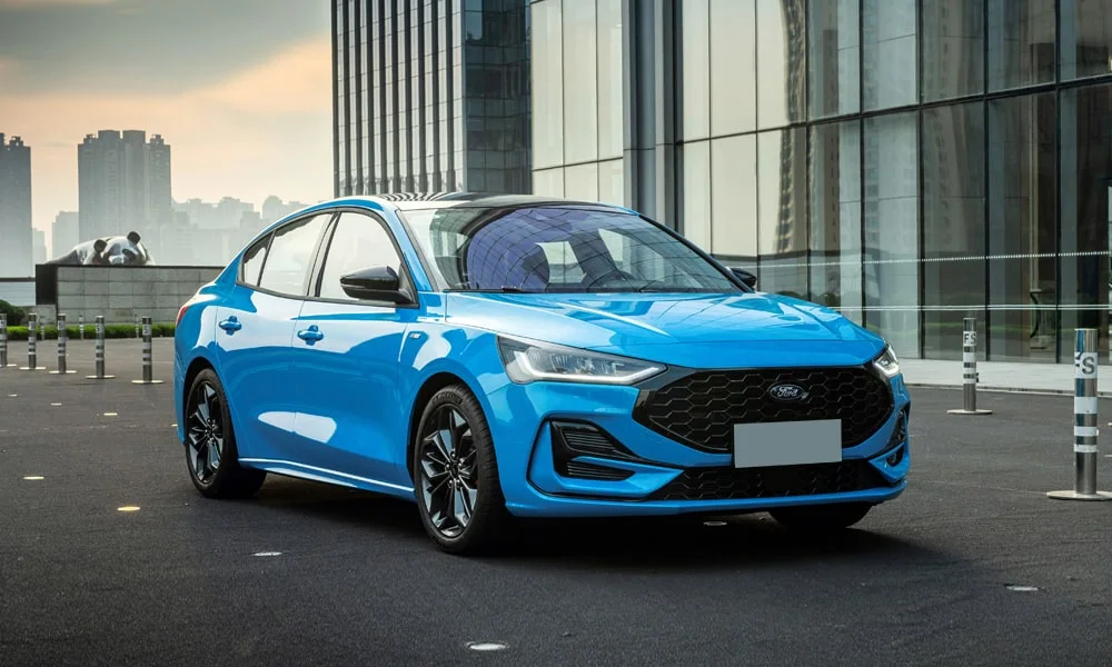 Фото Ford Focus (2024) — вид спереди, фото 8. Кузов в синем цвете: рисунок оптики и решётки задаёт узнаваемое «лицо» модели. Рисунок ходовых огней — подпись модели, по нему её узнают в потоке Ford Focus (2024) — вид спереди, фото 8