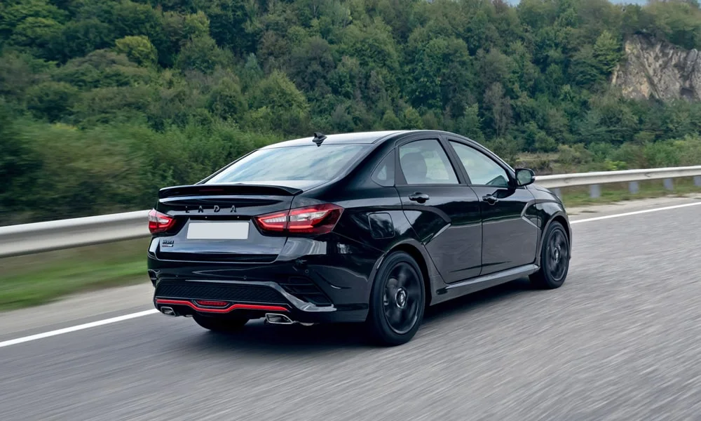Фото LADA Vesta Sportline (2023) — вид сзади, фото 3. Корма в чёрном цвете: графика фонарей и пластика пятой двери. Насадки выхлопа или их имитация внизу бампера различают версии LADA Vesta Sportline (2023) — вид сзади, фото 3