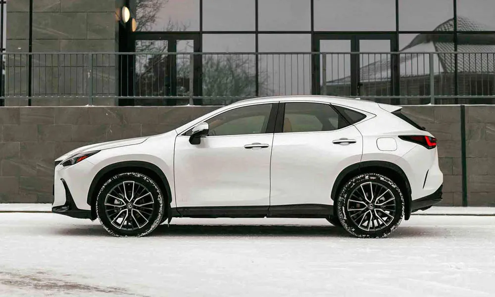 Фото Lexus NX 250 — вид сбоку, фото 2. Белый кузов в профиль — пропорции, высота посадки и дизайн дисков. Хромированные или чёрные молдинги окон отличают комплектации Lexus NX 250 — вид сбоку, фото 2