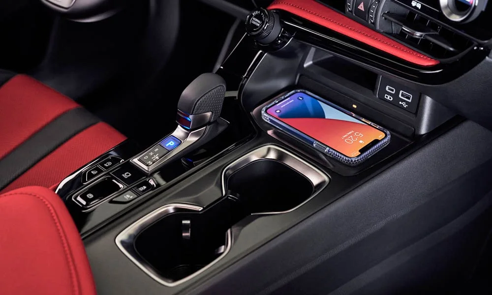 Фото Lexus NX 350 — беспроводная зарядка. Площадка для смартфона: зарядка без проводов. Прорезиненное покрытие удерживает телефон в поворотах; мощность зарядки — в характеристиках версии Lexus NX 350 — беспроводная зарядка