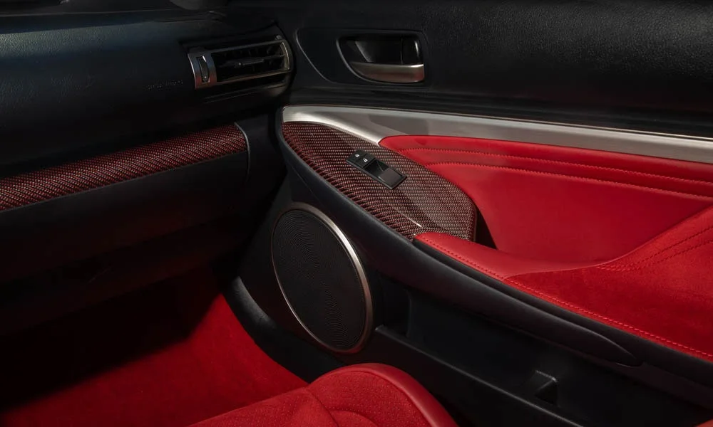 Фото Lexus RC F (2024) — дверная карта. Подлокотник, динамик и блок стеклоподъёмников. Мягкая вставка в зоне локтя — то, что чувствуешь каждый день Lexus RC F (2024) — дверная карта