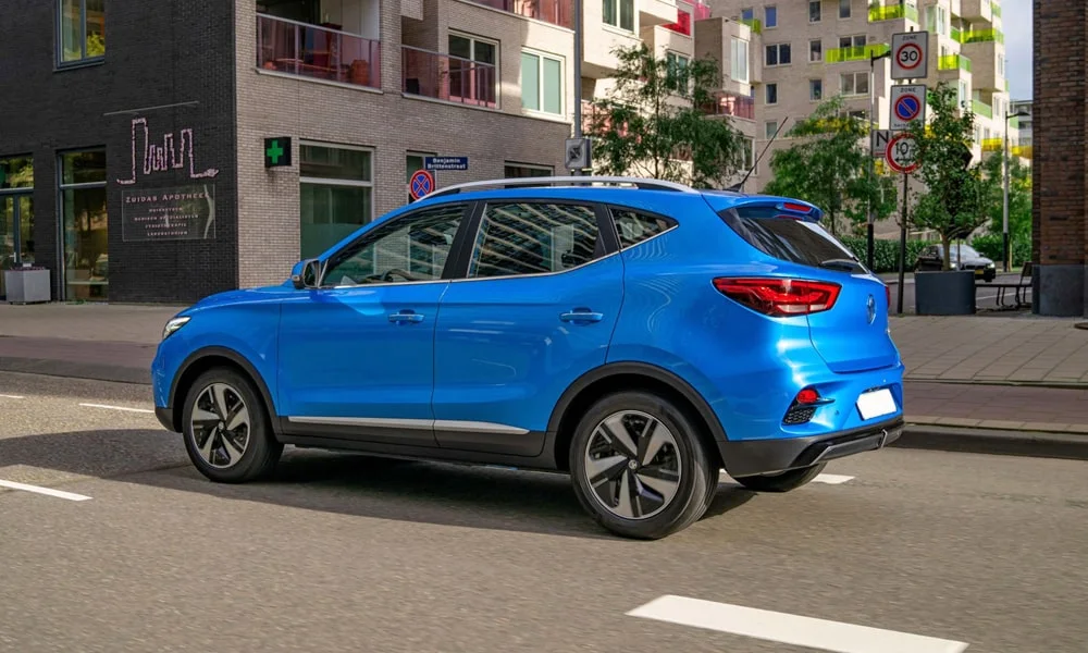 Фото MG ZS EV (2024) — вид сзади, фото 4. Синий кузов сзади — фонари и бампер определяют ночной образ модели. Насадки выхлопа или их имитация внизу бампера различают версии MG ZS EV (2024) — вид сзади, фото 4
