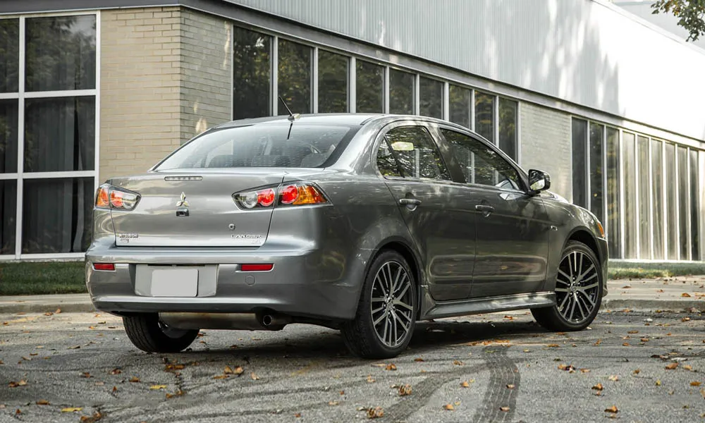 Фото Mitsubishi Lancer — вид сзади, фото 3. Линия крыши, стойки и задняя дверь в сером исполнении. Насадки выхлопа или их имитация внизу бампера различают версии Mitsubishi Lancer — вид сзади, фото 3