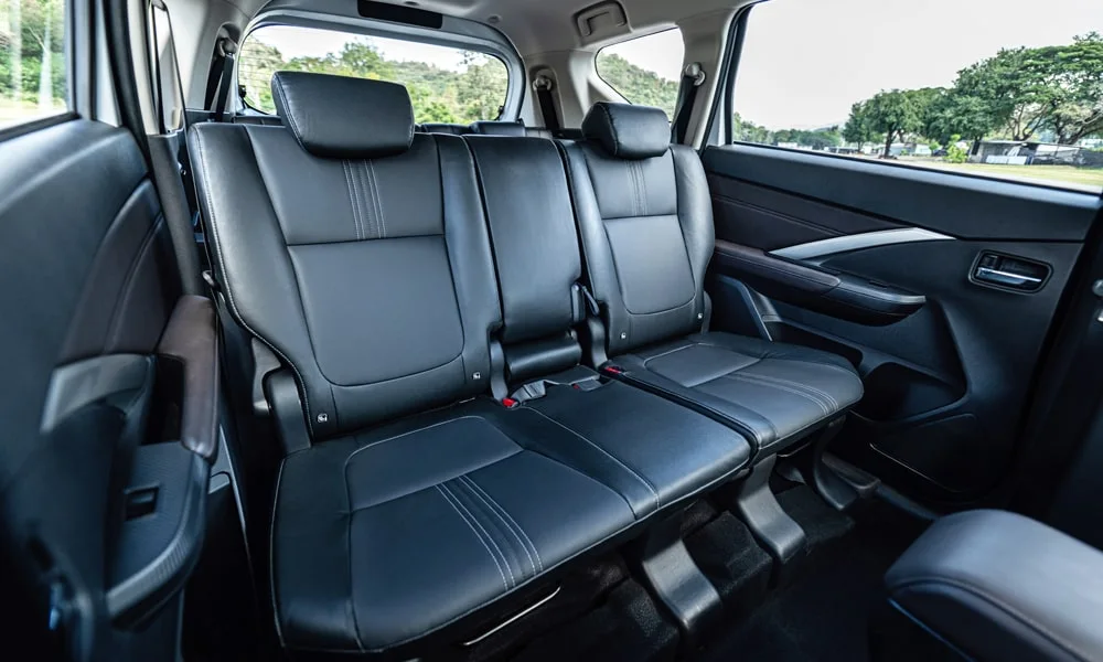 Фото Mitsubishi Xpander (2024) — задние сиденья. Второй ряд: профиль дивана, подголовники и обивка из гладкой коже. Плоский пол упрощает посадку втроём Mitsubishi Xpander (2024) — задние сиденья