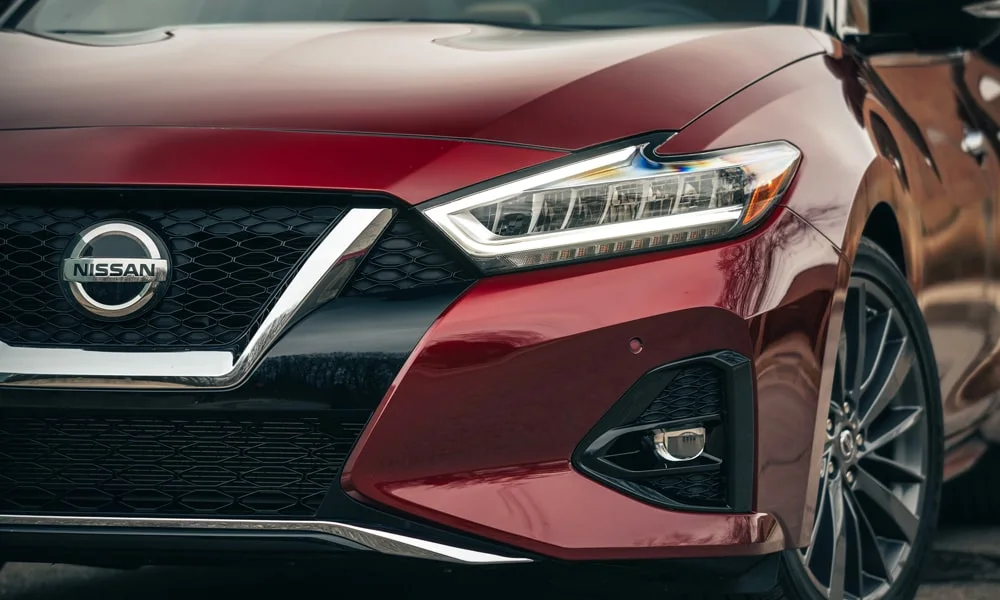 Фото Nissan Maxima — вид спереди, фото 6. Передок в красном исполнении — крупная светотехника и выразительный бампер. Рисунок ходовых огней — подпись модели, по нему её узнают в потоке Nissan Maxima — вид спереди, фото 6