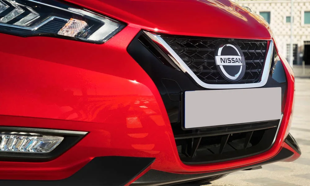 Фото Nissan Micra — вид спереди, фото 17. Кузов в красном цвете: рисунок оптики и решётки задаёт узнаваемое «лицо» модели Nissan Micra — вид спереди, фото 17