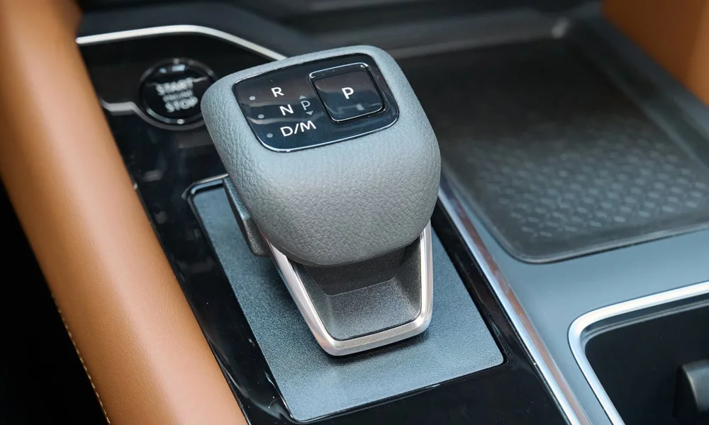 Фото Nissan Pathfinder (2022) — селектор коробки передач. Управление коробкой: компактный селектор освобождает место на тоннеле. Режимы движения и электронный ручник собраны рядом с селектором Nissan Pathfinder (2022) — селектор коробки передач