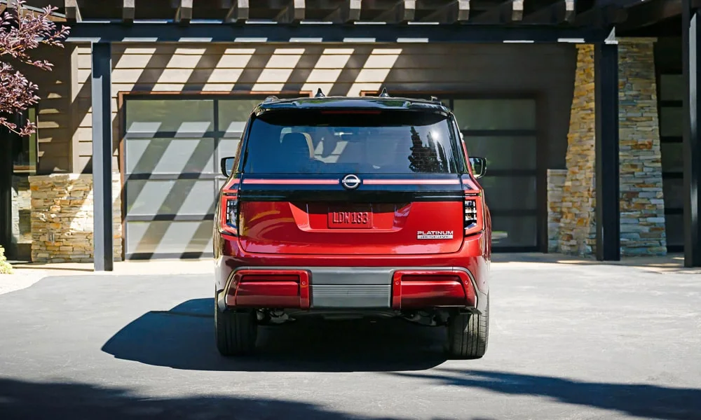 Фото Nissan Patrol (2024) — вид сзади, фото 6. Красный кузов сзади — фонари и бампер определяют ночной образ модели. Светодиодная полоса или раздельные секции — задняя оптика стала главным украшением кормы Nissan Patrol (2024) — вид сзади, фото 6