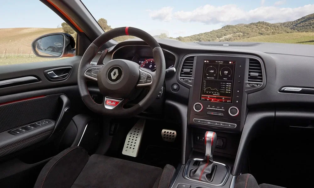 Фото Renault Megane RS — руль. Обшивка обода и компоновка спиц крупным планом. Клавиши на спицах управляют медиа, круизом и ассистентами — руки остаются на руле Renault Megane RS — руль