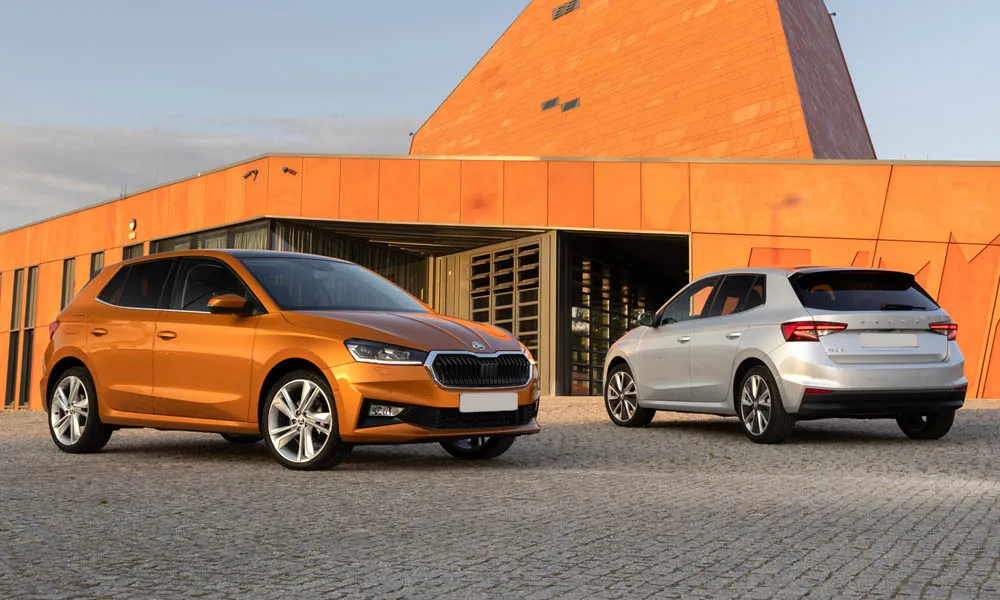 Фото Skoda Fabia — вид спереди, фото 8. Кузов в оранжевом цвете: рисунок оптики и решётки задаёт узнаваемое «лицо» модели. Рисунок ходовых огней — подпись модели, по нему её узнают в потоке Skoda Fabia — вид спереди, фото 8