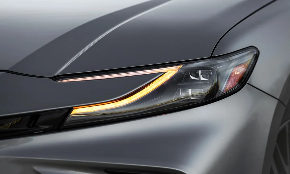 Фото Toyota Camry (2024) — передняя оптика. Начинка фары: модули ближнего и дальнего света, ходовые огни. Автоматический дальний свет сам переключается при встречном разъезде — есть у ряда версий Toyota Camry (2024) — передняя оптика