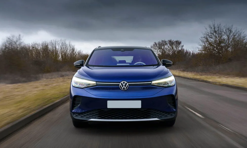 Фото Volkswagen ID 4 — вид спереди, фото 3. Передок в синем исполнении — крупная светотехника и выразительный бампер. Дневные ходовые огни включаются автоматически с запуском Volkswagen ID 4 — вид спереди, фото 3