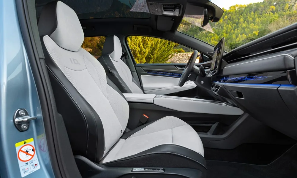 Фото Volkswagen ID 7 Tourer (2024) — интерьер. Общий план салона: архитектура панели, консоль и кресла. Уровень отделки читается по стыкам панелей и мягким поверхностям в зонах касания Volkswagen ID 7 Tourer (2024) — интерьер