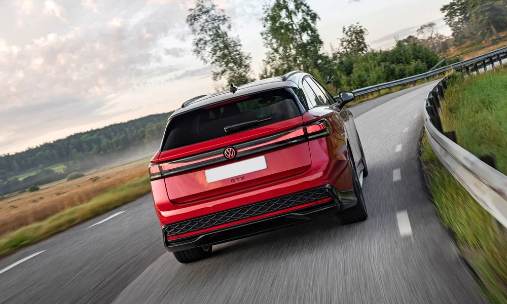 Фото Volkswagen ID 7 Tourer (2024) — вид сзади, фото 4. Корма в красном цвете: графика фонарей и пластика пятой двери. Светодиодная полоса или раздельные секции — задняя оптика стала главным украшением кормы Volkswagen ID 7 Tourer (2024) — вид сзади, фото 4