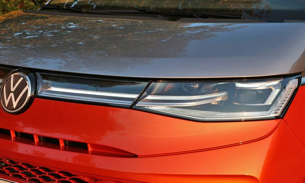 Фото Volkswagen Multivan (2024) — вид спереди, фото 6. Оптика, решётка и бампер — первое впечатление о модели. Рисунок ходовых огней — подпись модели, по нему её узнают в потоке Volkswagen Multivan (2024) — вид спереди, фото 6