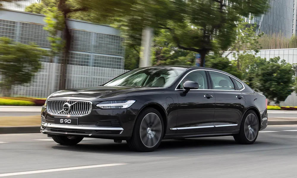 Фото Volvo S90 — вид спереди, фото 6. Кузов в чёрном цвете: рисунок оптики и решётки задаёт узнаваемое «лицо» модели. Рисунок ходовых огней — подпись модели, по нему её узнают в потоке Volvo S90 — вид спереди, фото 6